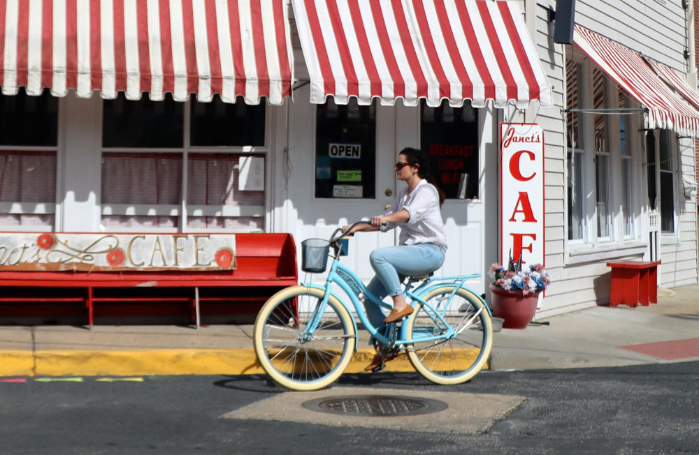 A woman leisurely riding a bicycle. 